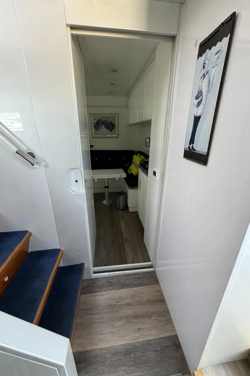 Slide: The Image of Interior of 1990 Versilcraft Challenger Motor Yacht with modern decor and staircase. - 29