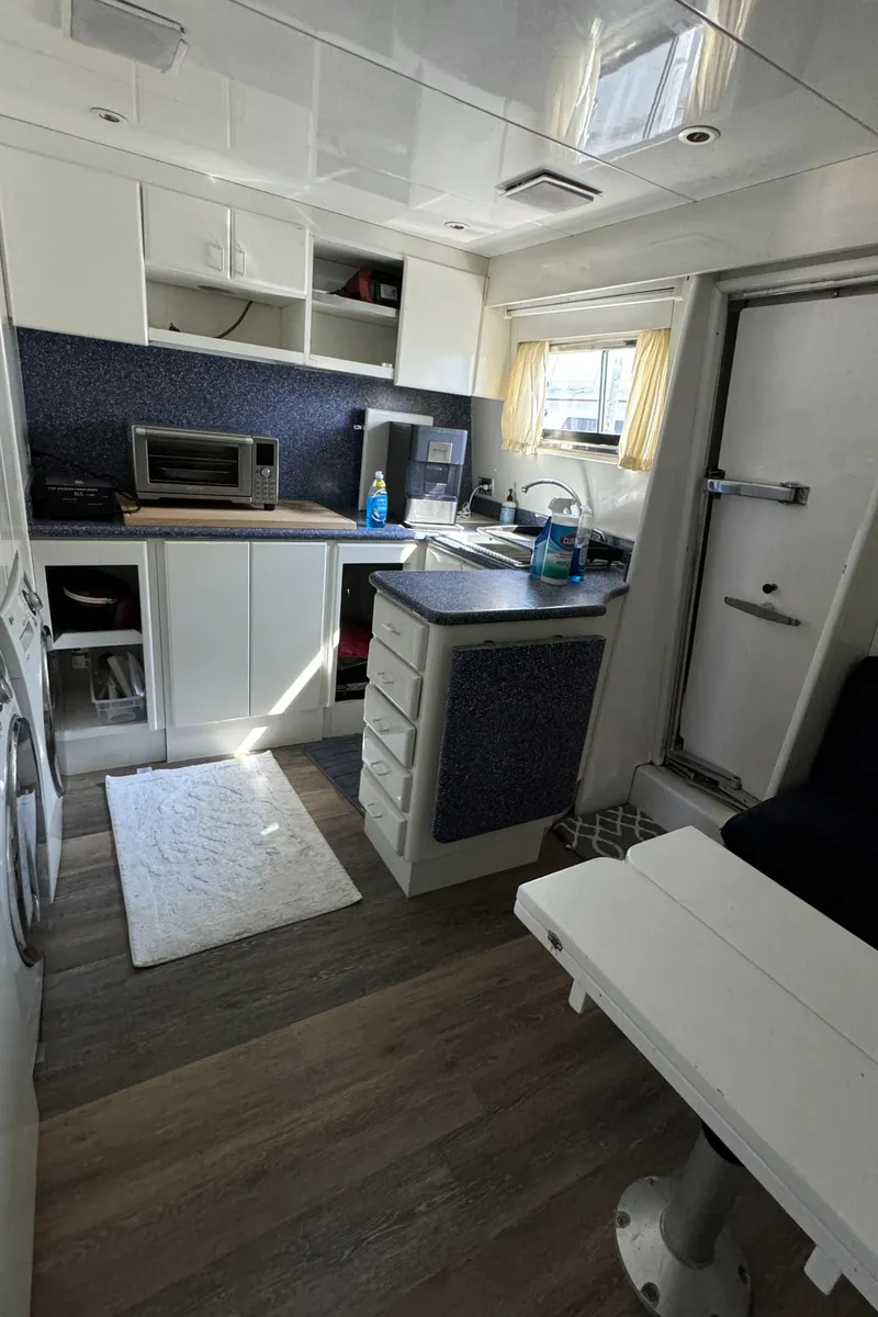 Slide: The Image of Interior of 1990 Versilcraft Challenger Motor Yacht with modern kitchen and dining area. - 30