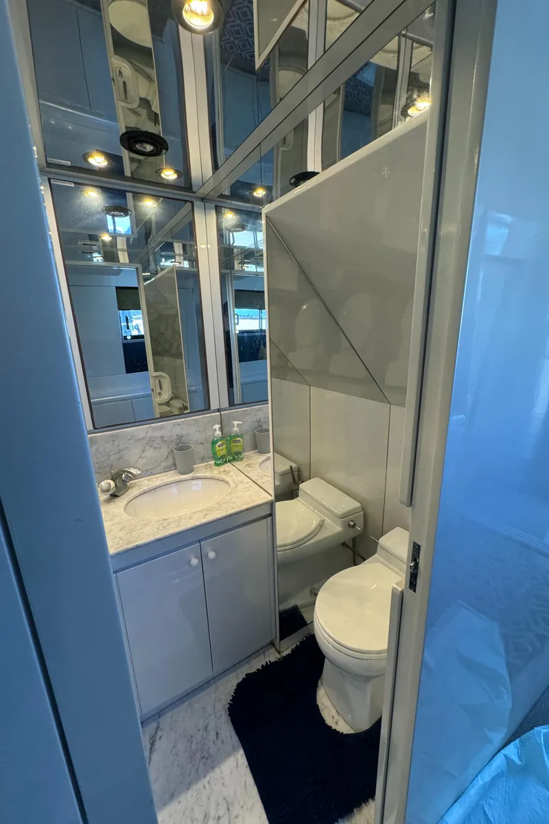 Slide: The Image of Luxurious bathroom in 1990 Versilcraft Challenger Motor Yacht with modern fixtures and mirrored walls. - 33