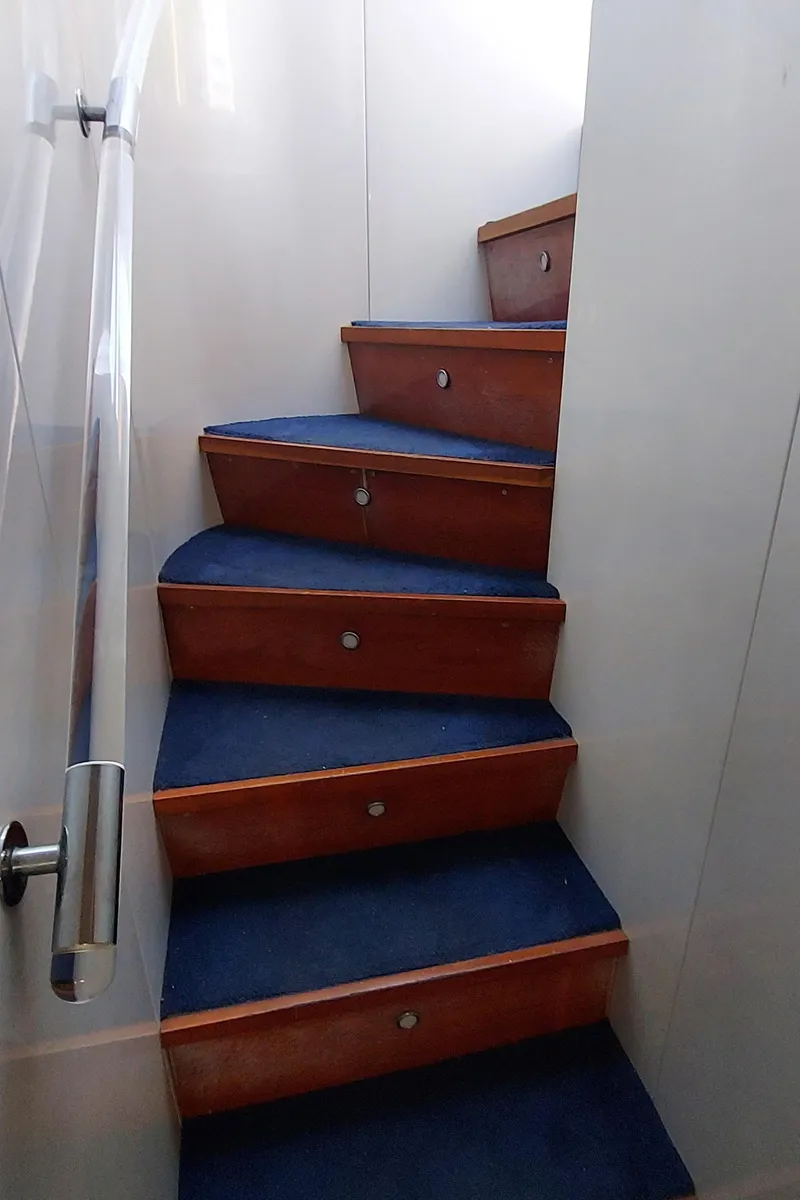 Slide: The Image of Staircase with blue carpet on 1990 Versilcraft Challenger Motor Yacht. - 36