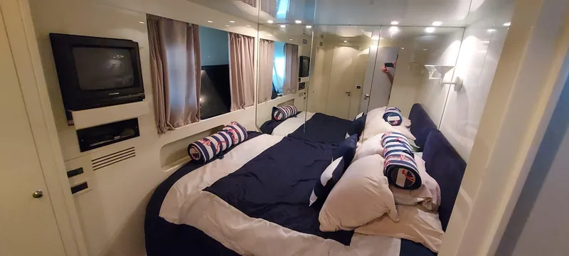 Slide: The Image of Luxurious bedroom interior of 1990 Versilcraft Challenger Motor Yacht with cozy bedding and TV. - 37