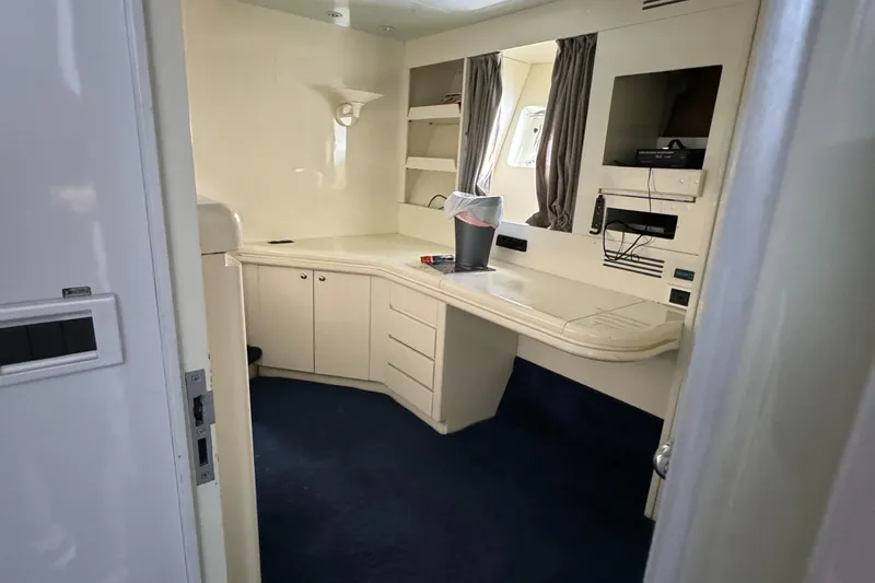 Slide: The Image of 1990 Versilcraft Challenger Motor Yacht interior with desk, TV, and storage cabinets. - 38