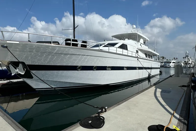 Slide: The Image of 1990 Versilcraft Challenger Motor Yacht docked at marina under blue sky. - 4