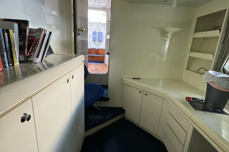 Slide: The Image of Interior of 1990 Versilcraft Challenger Motor Yacht with white cabinetry and blue carpet. - 41