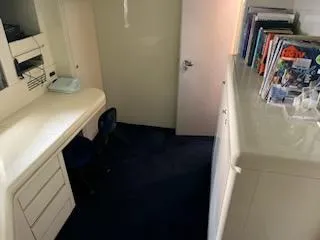 Slide: The Image of 1990 Versilcraft Challenger Motor Yacht interior with desk, chair, and bookshelf. - 42