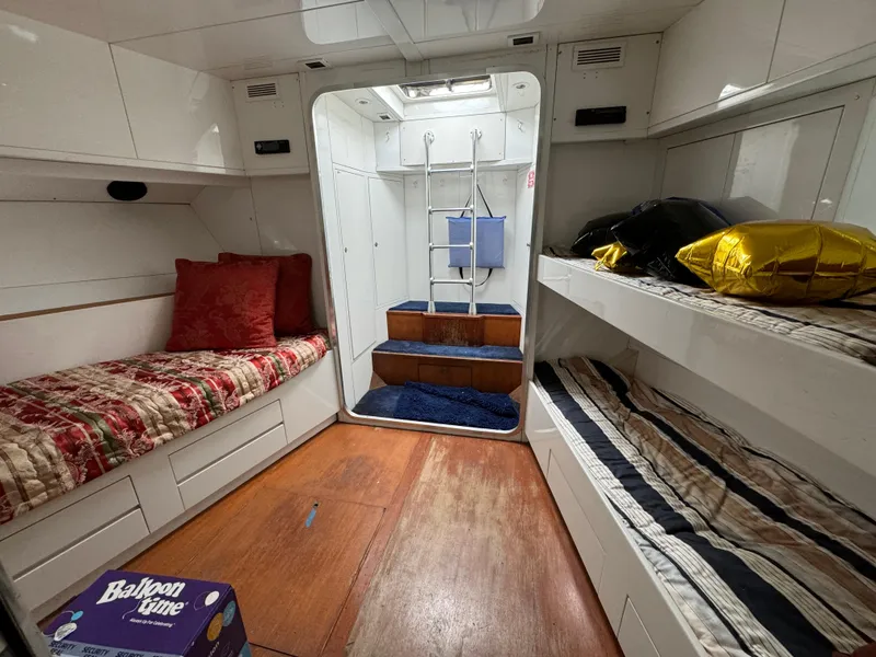 Slide: The Image of Interior of 1990 Versilcraft Challenger Motor Yacht with cozy bunks and wooden flooring. - 43