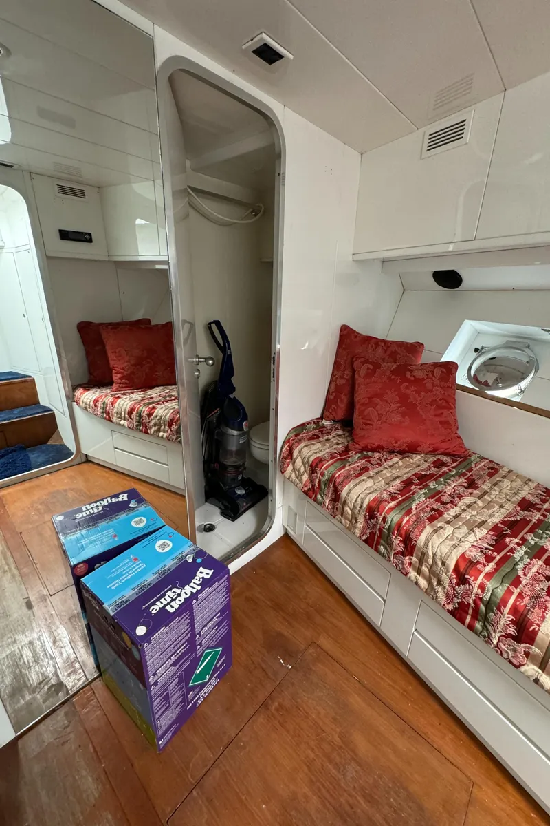 Slide: The Image of Interior of 1990 Versilcraft Challenger Motor Yacht with cozy seating and wooden flooring. - 46