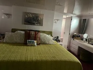 Slide: The Image of Luxurious bedroom interior of 1990 Versilcraft Challenger Motor Yacht with elegant decor. - 49