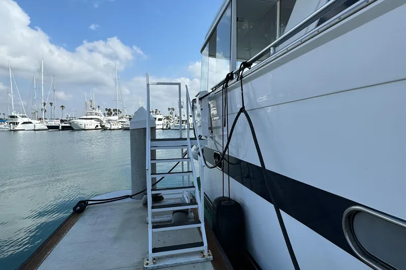 Slide: The Image of Versilcraft Challenger Motor Yacht 1990 docked at marina with boarding ladder. - 6
