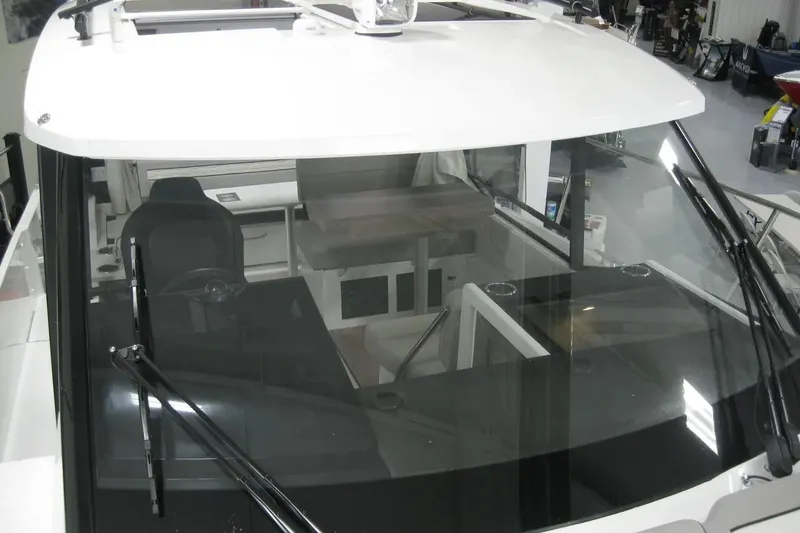 Slide: The Image of Interior seating area of 2026 Jeanneau NC 895 Series 2 boat with table and cup holders. - 10