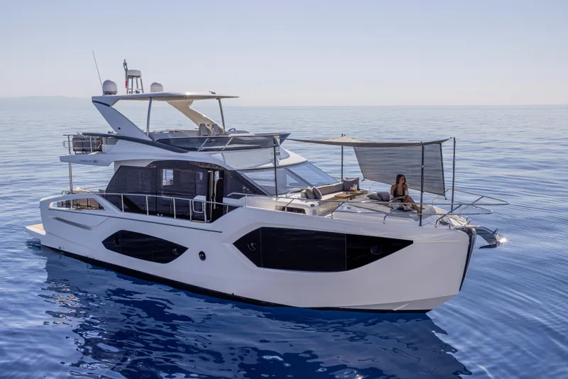 Slide: The Image of Luxury Absolute 56 FLY yacht, 2025 model, cruising on serene blue waters. - 1