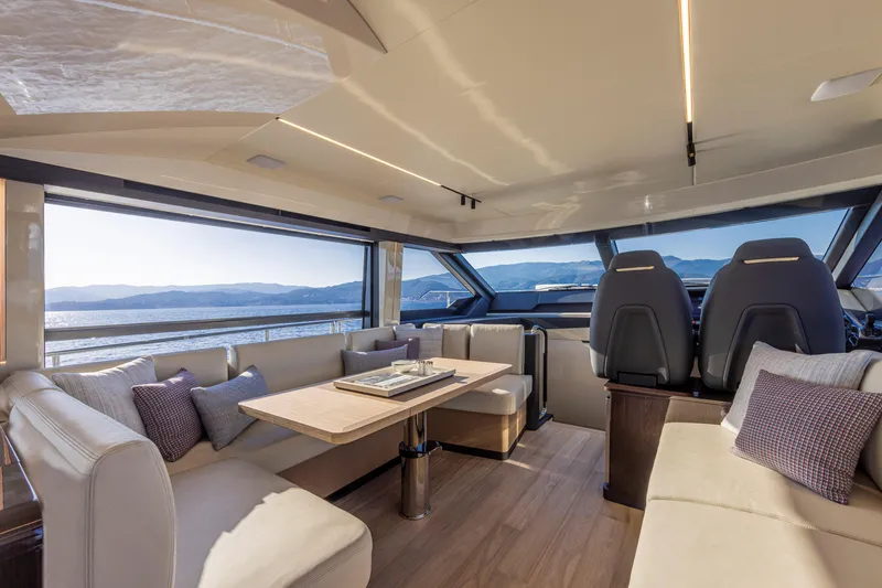 Slide: The Image of Luxurious interior of 2025 Absolute 56 FLY yacht with panoramic windows and elegant seating. - 32