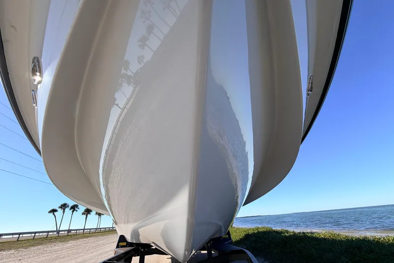 Slide: The Image of 2021 Chittum Skiffs Islamorada 18 boat hull, close-up view by the water. - 10
