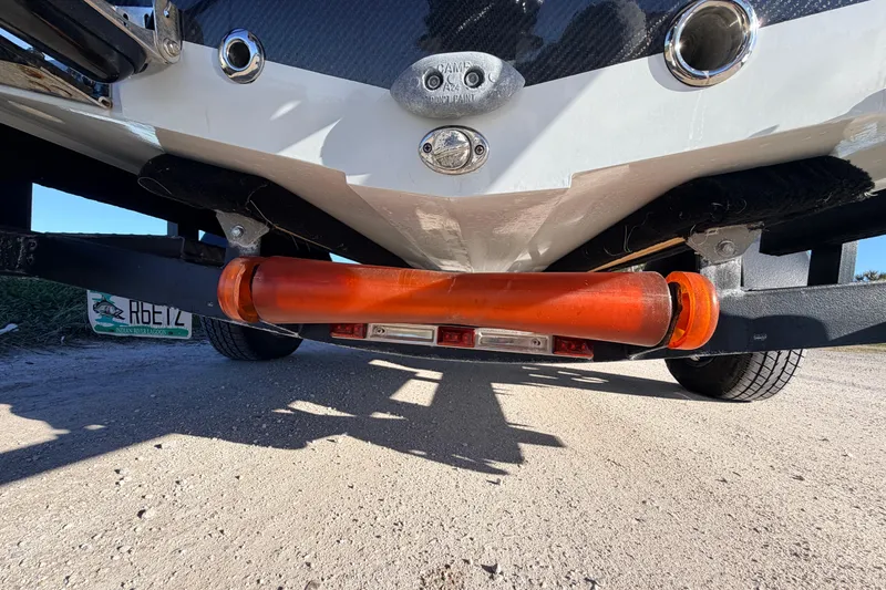 Slide: The Image of 2021 Chittum Skiffs Islamorada 18 boat trailer with orange roller and license plate. - 16