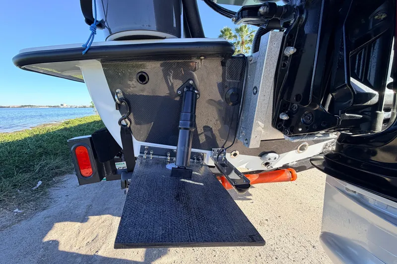 Slide: The Image of 2021 Chittum Skiffs Islamorada 18 boat transom detail by the water. - 19