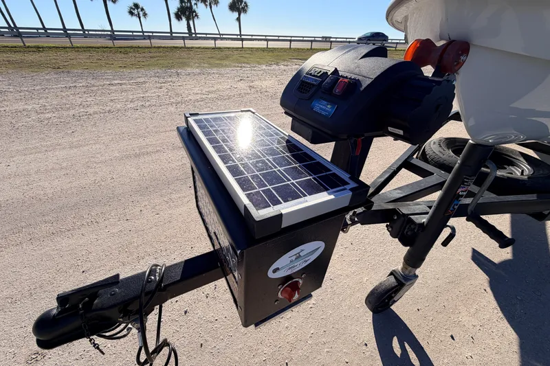 Slide: The Image of 2021 Chittum Skiffs Islamorada 18 trailer with solar panel in sunny outdoor setting. - 22