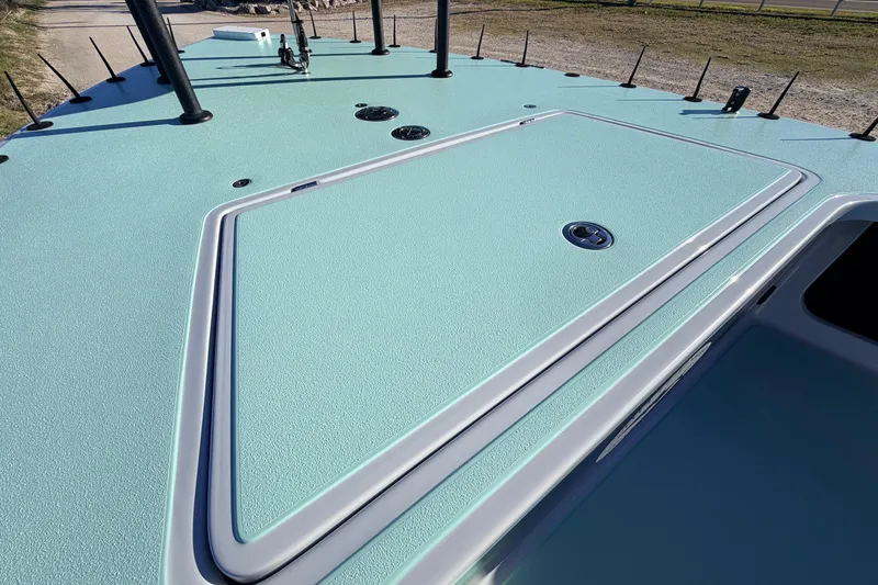 Slide: The Image of 2021 Chittum Skiffs Islamorada 18 deck, featuring a sleek, textured surface design. - 28