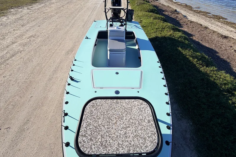 Slide: The Image of 2021 Chittum Skiffs Islamorada 18 boat on sandy shore, featuring sleek design and spacious deck. - 36