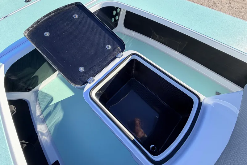 Slide: The Image of 2021 Chittum Skiffs Islamorada 18 boat storage compartment with open lid. - 40