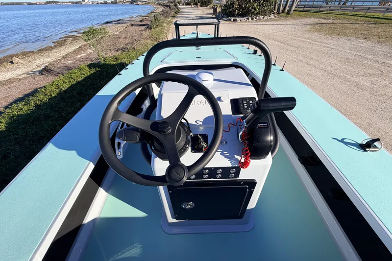 Slide: The Image of 2021 Chittum Skiffs Islamorada 18 boat interior with steering wheel and controls. - 42