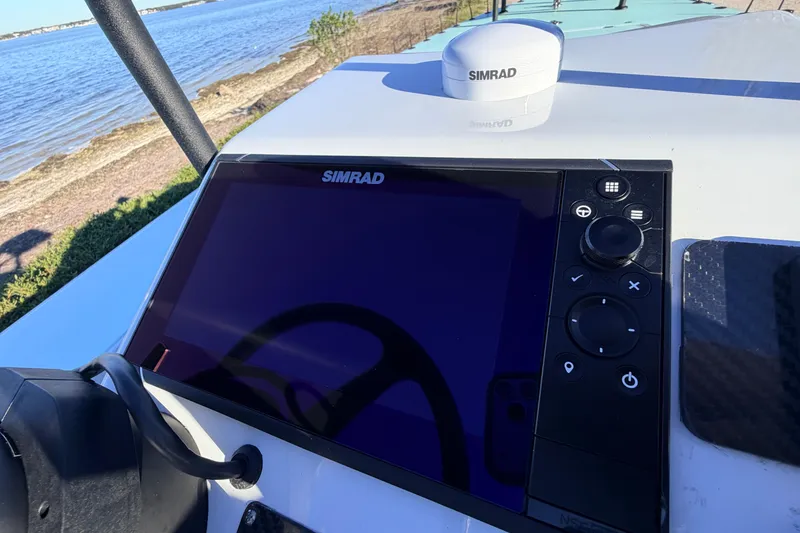 Slide: The Image of Simrad navigation system on 2021 Chittum Skiffs Islamorada 18, near a scenic shoreline. - 45