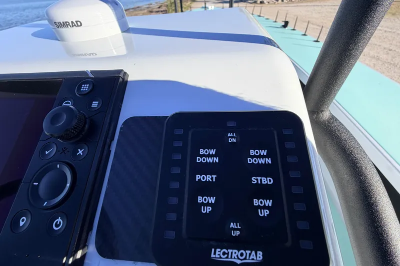 Slide: The Image of Control panel of 2021 Chittum Skiffs Islamorada 18 with Simrad electronics and Lectrotab trim controls. - 46