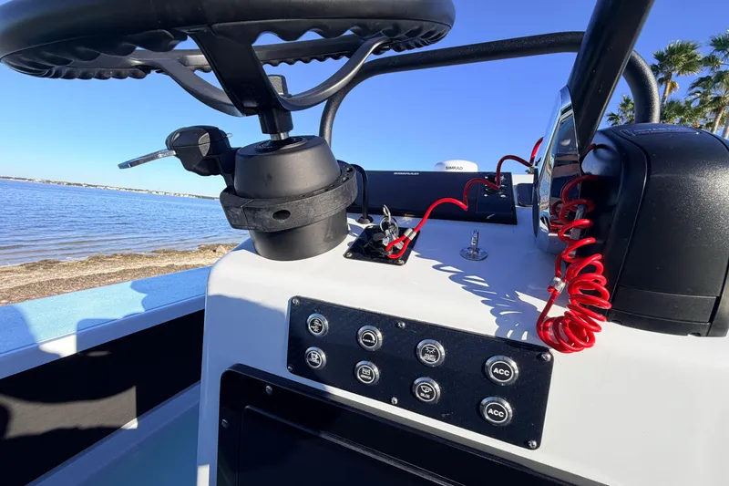 Slide: The Image of 2021 Chittum Skiffs Islamorada 18 boat console with steering wheel and control panel. - 47
