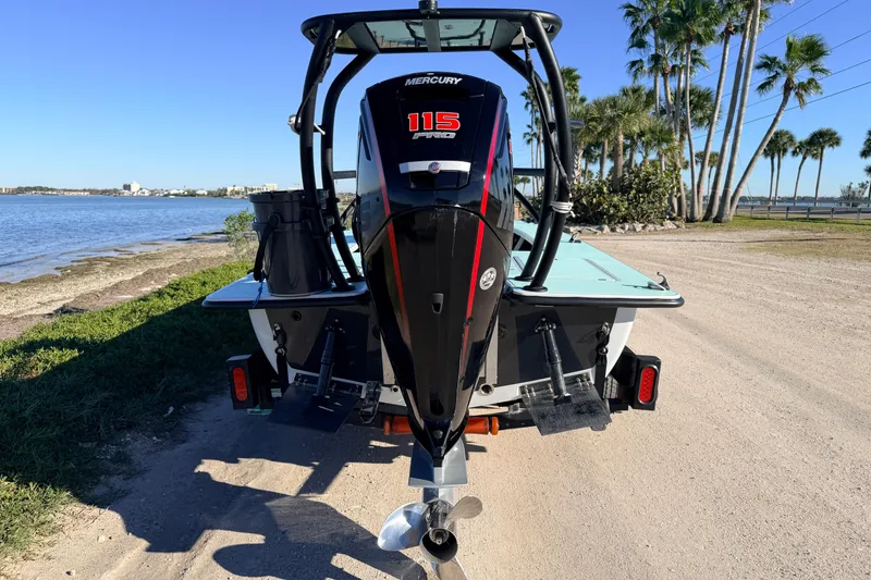 Slide: The Image of 2021 Chittum Skiffs Islamorada 18 with Mercury 115 engine by a scenic waterfront. - 5