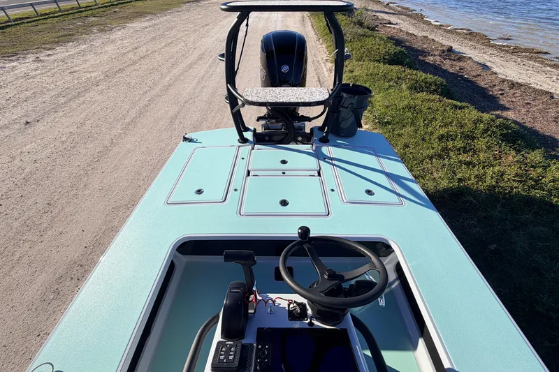 Slide: The Image of 2021 Chittum Skiffs Islamorada 18 boat on a sandy shore near water. - 52