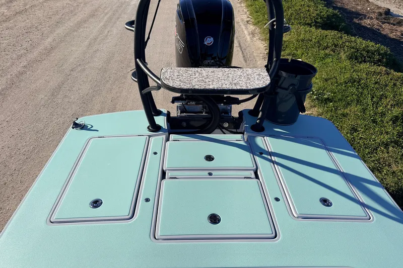 Slide: The Image of 2021 Chittum Skiffs Islamorada 18 boat deck with storage compartments and motor. - 53