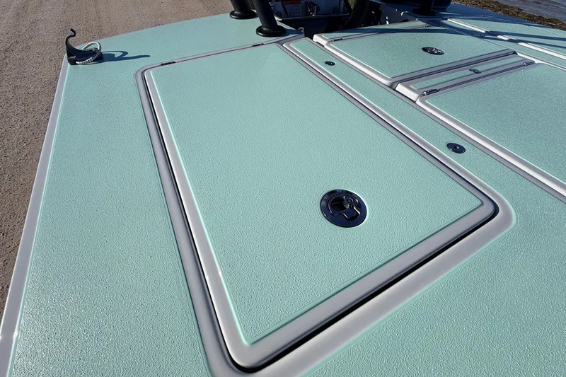 Slide: The Image of 2021 Chittum Skiffs Islamorada 18 deck with textured surface and storage compartments. - 54