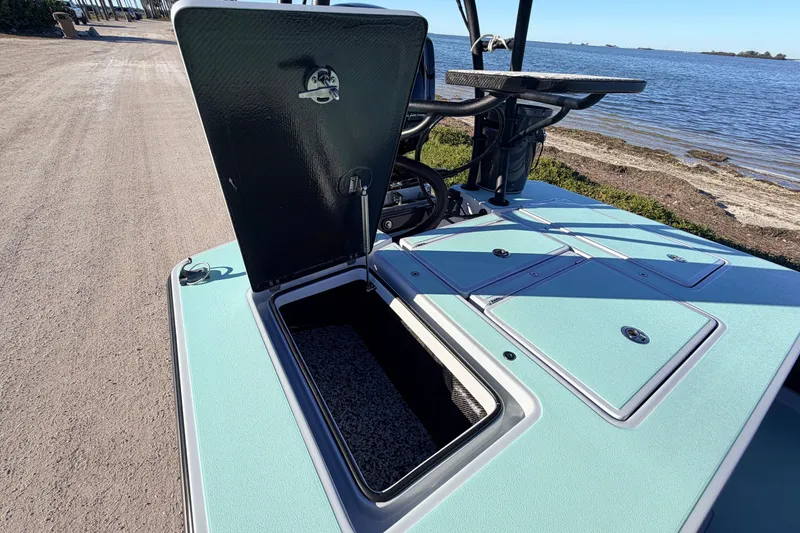 Slide: The Image of 2021 Chittum Skiffs Islamorada 18 with open storage compartment by the water. - 55