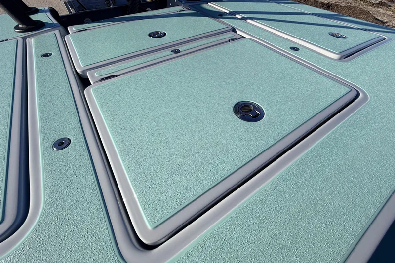 Slide: The Image of 2021 Chittum Skiffs Islamorada 18 deck with textured surface and storage hatches. - 57