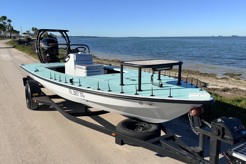 Slide: The Image of 2021 Chittum Skiffs Islamorada 18 boat on trailer by the seaside. - 6