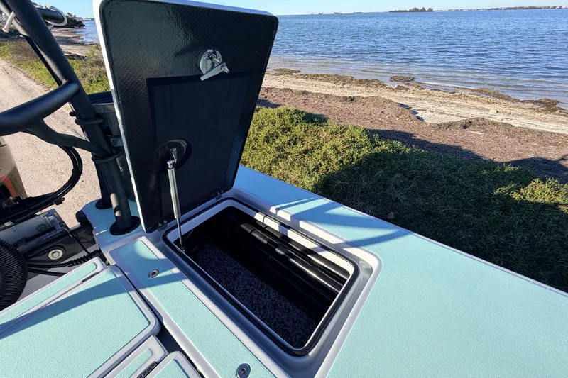 Slide: The Image of 2021 Chittum Skiffs Islamorada 18 boat hatch open by the water. - 61