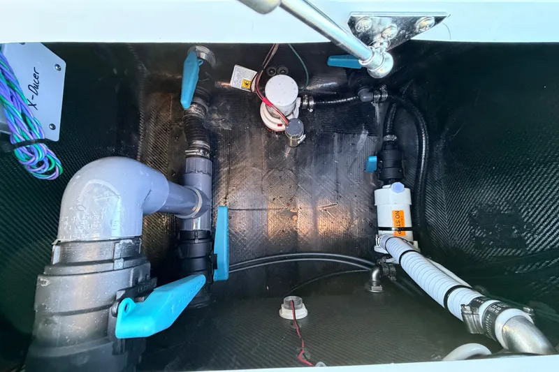 Slide: The Image of 2021 Chittum Skiffs Islamorada 18 bilge area with plumbing and wiring components. - 67