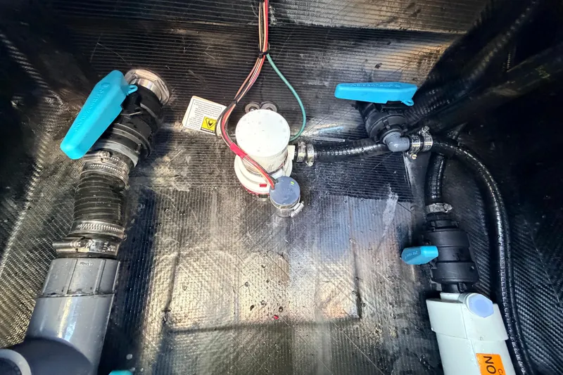 Slide: The Image of Bilge area of 2021 Chittum Skiffs Islamorada 18 with plumbing and wiring components. - 68