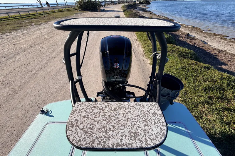 Slide: The Image of 2021 Chittum Skiffs Islamorada 18 boat with motor, parked by a scenic coastal road. - 73