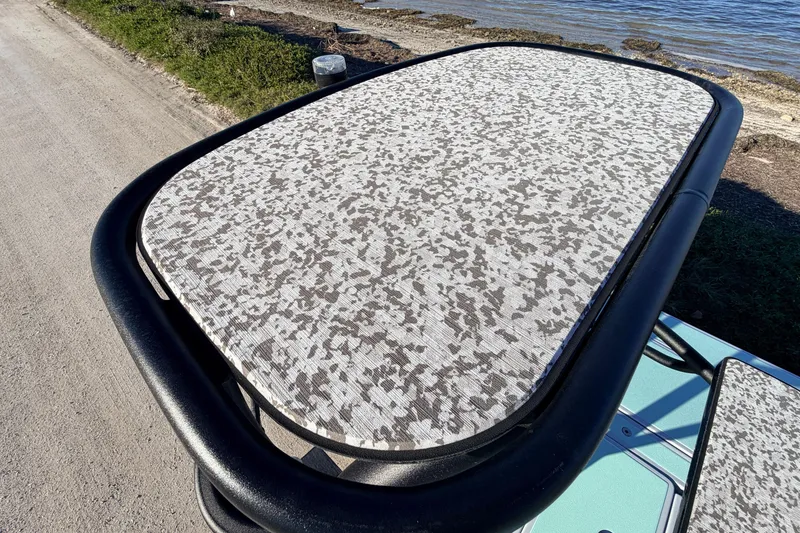 Slide: The Image of 2021 Chittum Skiffs Islamorada 18 with camo-patterned deck near shoreline. - 74