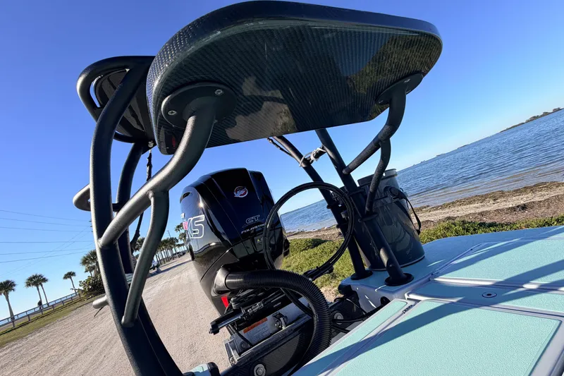 Slide: The Image of 2021 Chittum Skiffs Islamorada 18 boat with motor, near a scenic waterfront. - 75