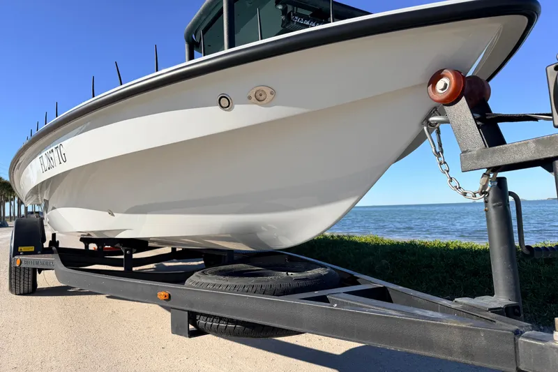 Slide: The Image of 2021 Chittum Skiffs Islamorada 18 boat on trailer by the water. - 9