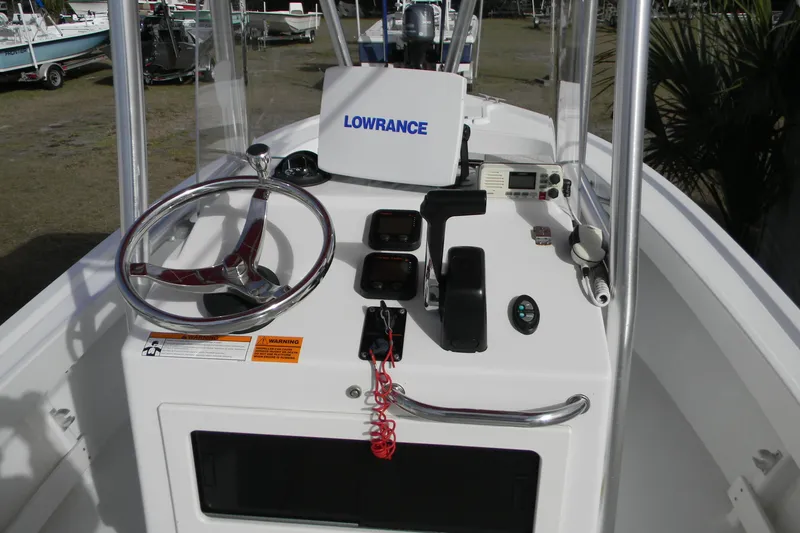 Slide: The Image of 2014 Parker 1801 Center Console boat dashboard with steering wheel and navigation equipment. - 7