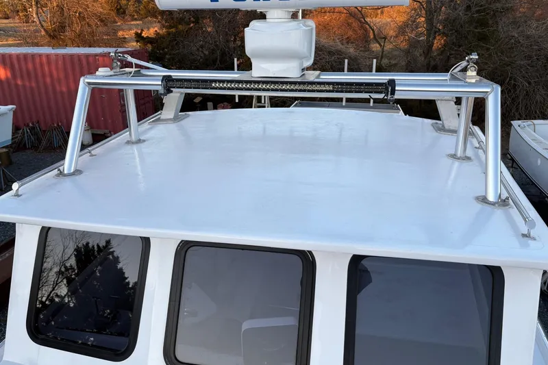 Slide: The Image of Custom 1994 workboat with metal roof rack and radar, docked near red container. - 13