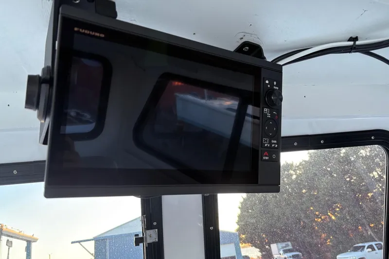 Slide: The Image of Interior of a 1994 custom workboat featuring a mounted navigation display. - 18