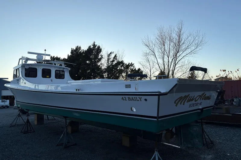 Slide: The Image of Custom 1994 workboat "Miss Alexis" on stands, with trees in the background. - 5
