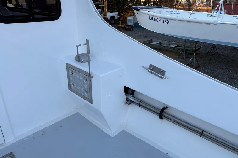 Slide: The Image of Custom 1994 workboat deck with metal fittings and adjacent docked boat. - 9