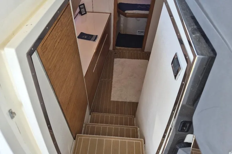 Slide: The Image of Interior view of 2013 Azimut 36 yacht, featuring wooden stairs and modern design. - 15