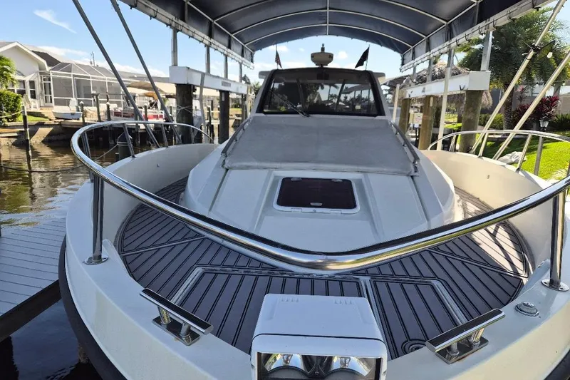 Slide: The Image of Azimut 36 yacht, 2013 model, docked under a canopy with sleek design features. - 6