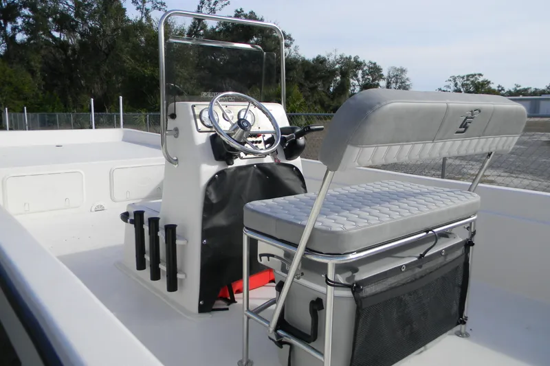 Slide: The Image of 2026 Carolina Skiff E24 DLX CC boat interior with steering console and seating. - 7