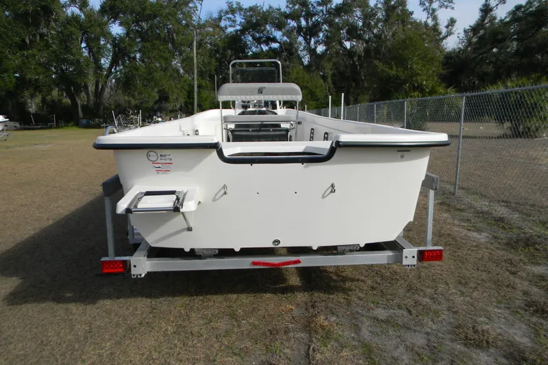 Slide: The Image of 2026 Carolina Skiff E24 DLX CC boat on trailer, rear view, outdoors. - 9